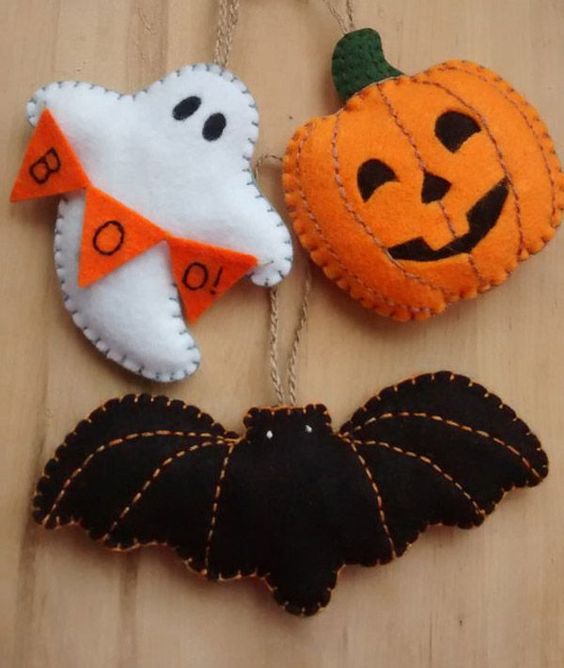 Halloween style felt ornaments with contrasting stitching, a banner and other detailing can be made for styling a tree