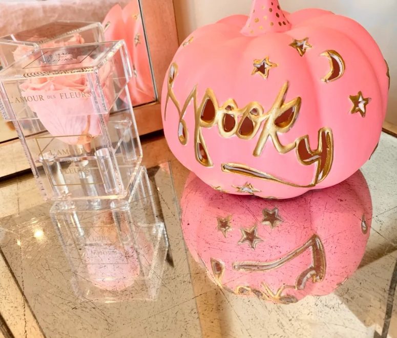 a carved pink pumpkin with gold detailing, moons and stars is a fantastic idea for Halloween