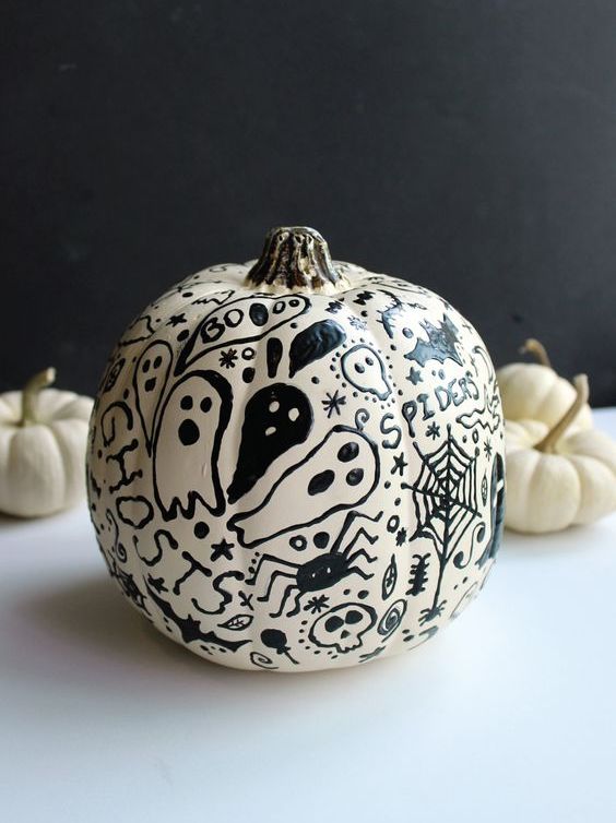 a cool and scary white pumpkin decorated with spiders, skulls and ghosts is a lovely idea for Halloween