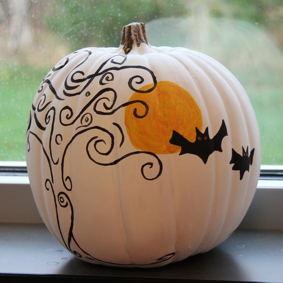a white pumpkin decorated with a black and an orange sharpie in Halloween style is a fun and cool idea to rock