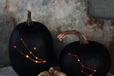 15 stylish black drilled pumpkins with lights inside instead of usual spooky carved ones