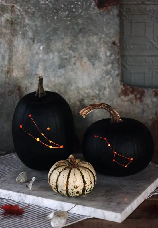 stylish black drilled pumpkins with lights inside instead of usual spooky carved ones