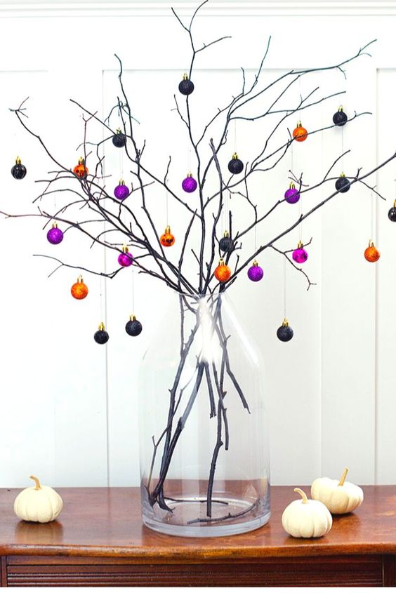 a branch Halloween tree with mini black, orange and purple ornaments - just buy some pretty colorful ones and create a tree