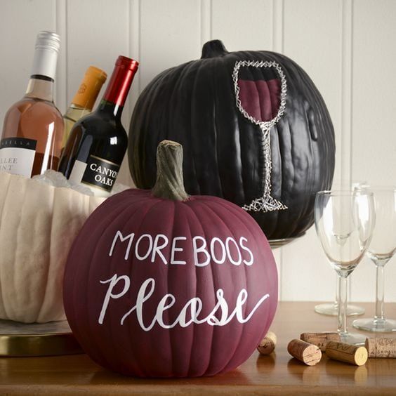 a matte burgundy pumpkin, a glossy black one with letters and a wine glass crafted on the pumpkin are amazing for Halloween