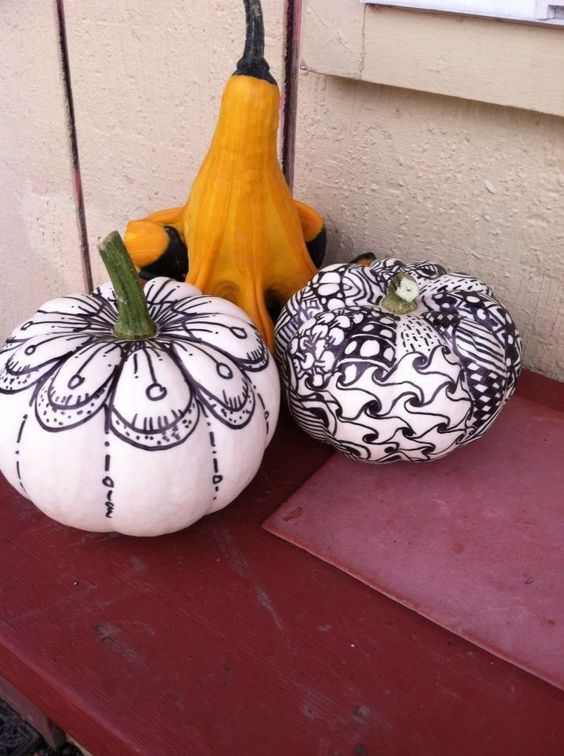 stylish and cool black and white pumpkins decorated with a black sharpie are a nice idea for Halloween, they look cute
