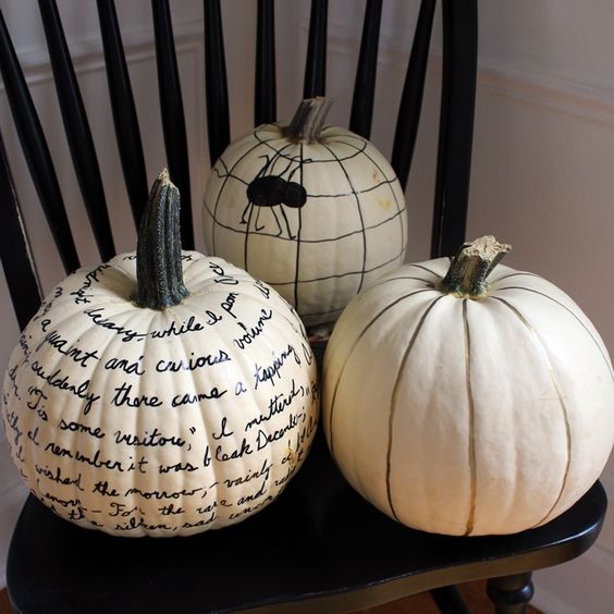 white pumpkins decorated with a black sharpie, with quotes, a spider and just stripes, will be a great last minute craft