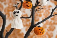 27 a black Halloween tree decorated with cute and fun pumpkin and ghost crochet ornaments are adorable for styling your space, and you can DIY them all