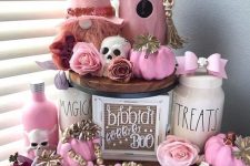 27 amazing pink Halloween decor with pink pumpkins, bottles, a gnome, some bows, beads and skulls is gorgeous