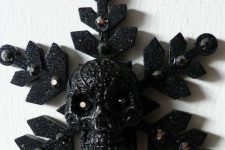 29 a cool dark Halloween ornament – a black snowflake with a skull, with rhinestones is amazing for styling a tree