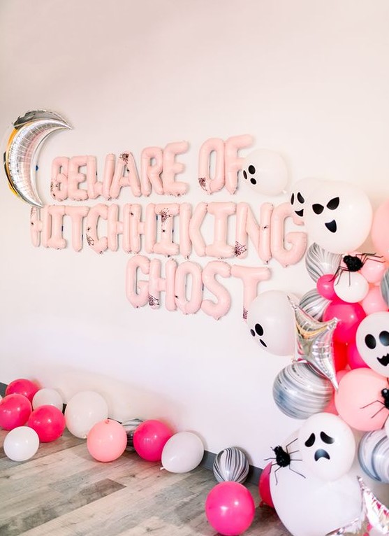 gorgeous pink Halloween styling with lots of balloons - pink, silver and scary ghost ones, pink balloon letters and a silver moon