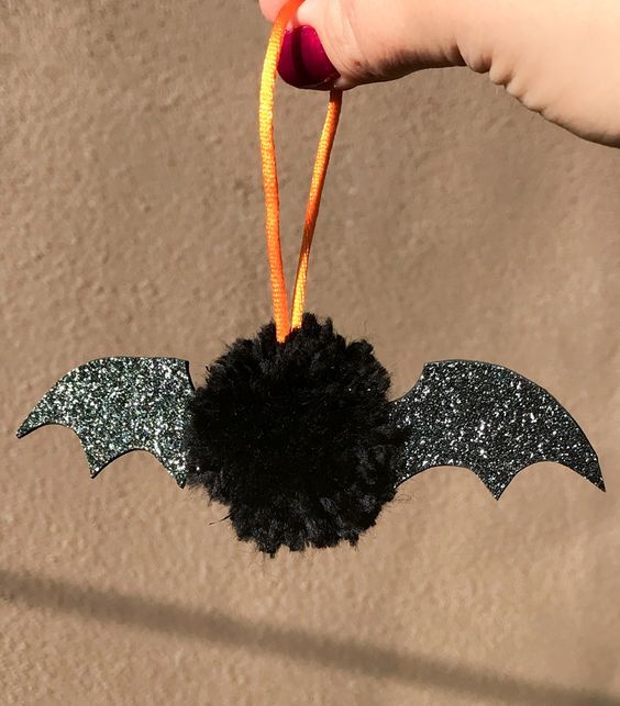 a fun and cute black bat Halloween ornament of a black pompom and black glitter wings is adorable for Halloween