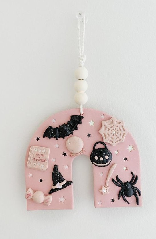 a lovely pink and black polymer clay Halloween ornament with bats, spiders, stars, hats and much more is the cutest