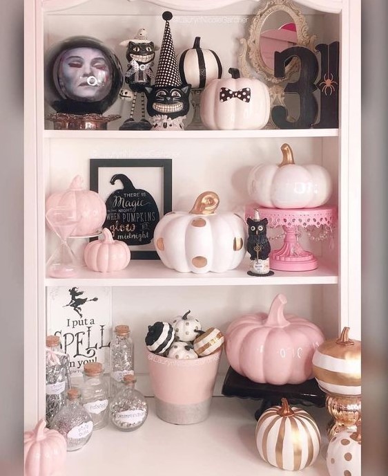 pretty Halloween decor with pink, blush and gold pumpkins, cats, stands and scary details is a gorgeous idea for this holiday