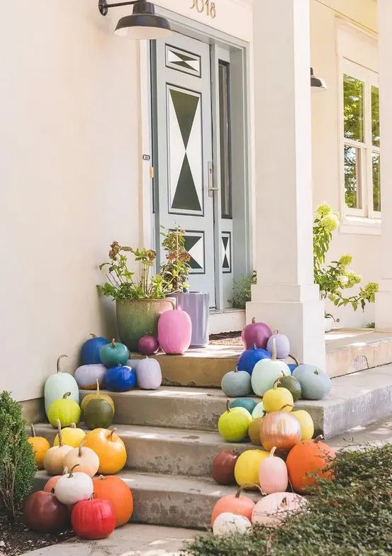 colorful pumpkins with gilded stems put on steps are amazing for fall and Halloween decor