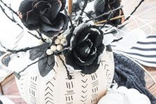 35 white pumpkins decorated with a black sharpie, with boho patterns and something scary, with black faux blooms and twigs are amazing