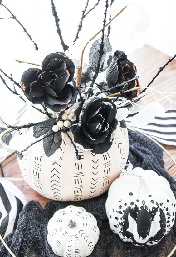 white pumpkins decorated with a black sharpie, with boho patterns and something scary, with black faux blooms and twigs are amazing