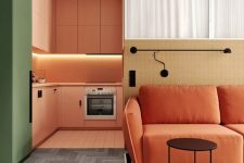 a bold modern space with an orange kitchen with built-in lights and a green fridge, a burnt orange sofa and a striped rug