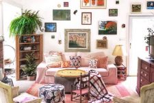 a bright eclectic gallery wall with mismatching frames climbing up the wall and going over the doorway is a very creative idea