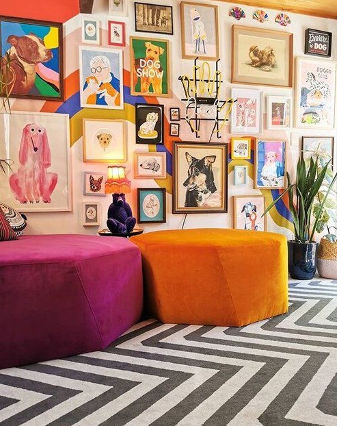a colorful and bold gallery wall with mismatching frames and super bold artworks in various styles placed on a wall with color block