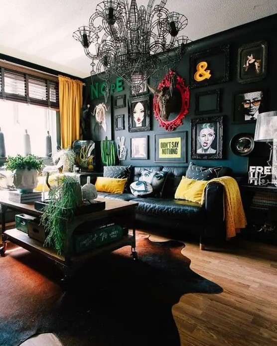 a dramatic gallery wall with various types of art, letters, ampersands and even empty frames looks amazing