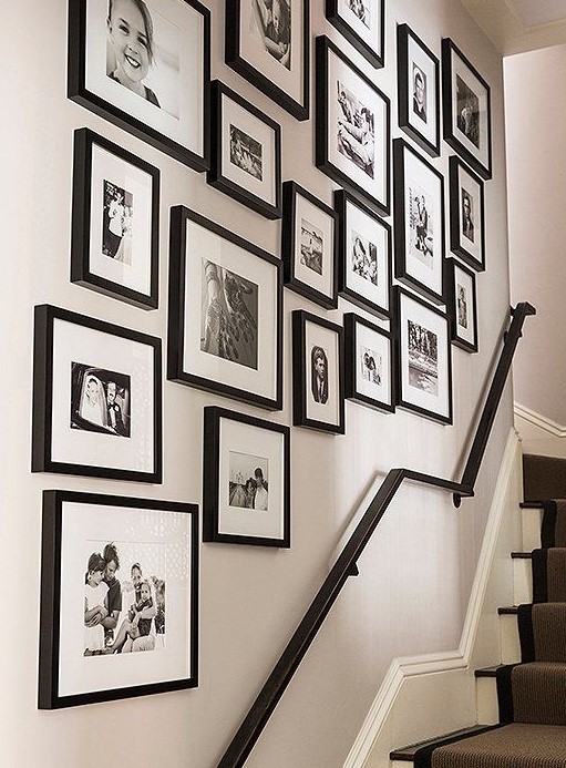 a free form gallery wall with mismatching black frames, black and white photos will refresh the space in a stylish way