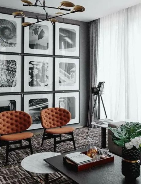 a grid gallery wall with thin black frames, white matting and black and white photos with curved angles feels retro chic