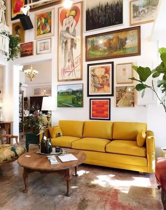 a large free form gallery wall with a bold color scheme and with vintage artworks will make the space more refined