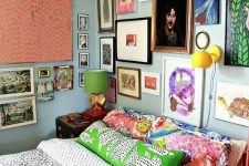 a maximalist gallery wall in various bright colors, with mismatching frames taking two walls looks very bold and cool