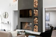 a stylish contemporary living room with a graphite grey concrete fireplace and niches for storage plus chic and stylish furniture