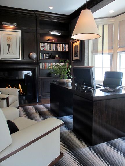 an elegant moody home office with dark built-in furniture, a dark furniture, a comfortable dark chair, creamy chairs
