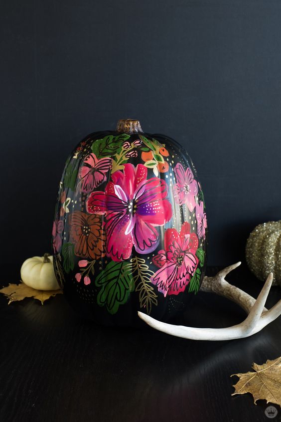 a jaw-dropping Halloween pumpkin - a black one with painted bold blooms and butterflies just wows