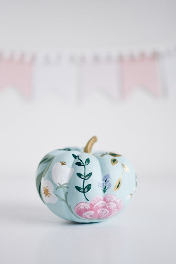 a pale blue pumpkin with beautiful flowers painted is a delicate and lovely idea for the fall and Thanksgiving