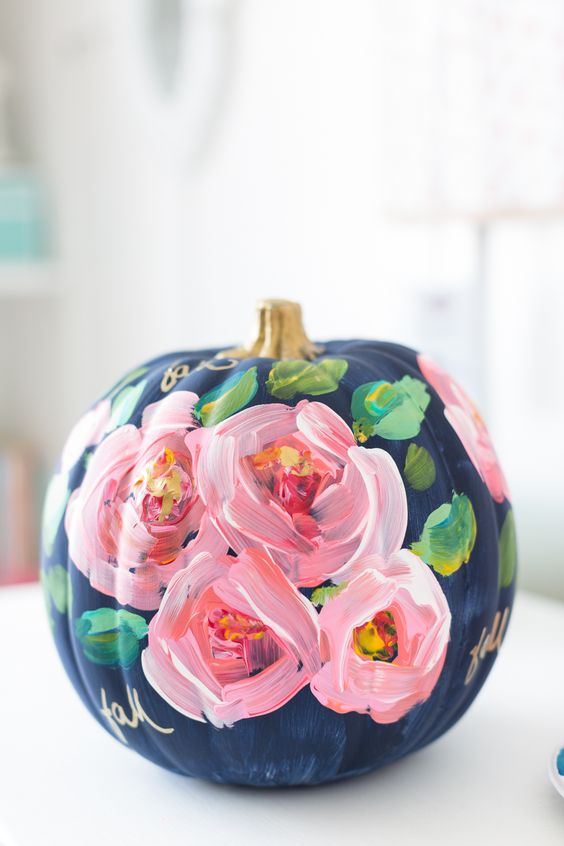 a stunning navy pumpkin decorated with pink blooms and foliage hand painted and with gold calligraphy for the fall