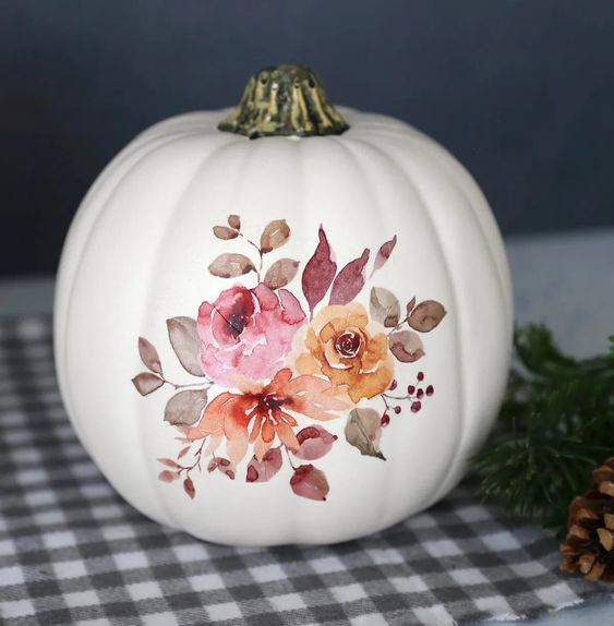 a super chic and elegant white pumpkin with pink and yellow blooms and leaves decoupaged is a lovely idea for the fall
