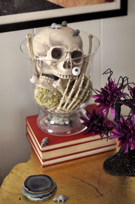 a clear bowl with a skull, skeleton hands, eyeballs and mice is a very easy last-minute Halloween decoration or centerpiece