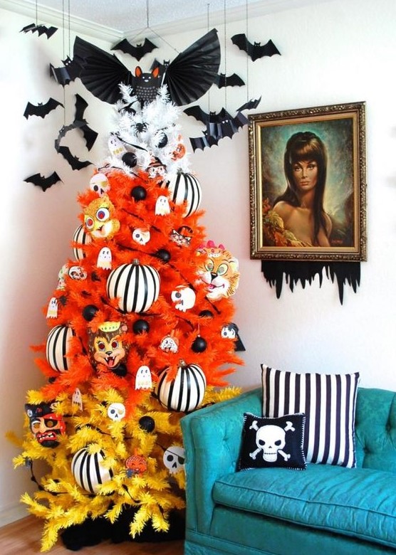 a gradient orange, yellow and white Halloween tree decorated with ghosts, striped ornaments, masks and bats