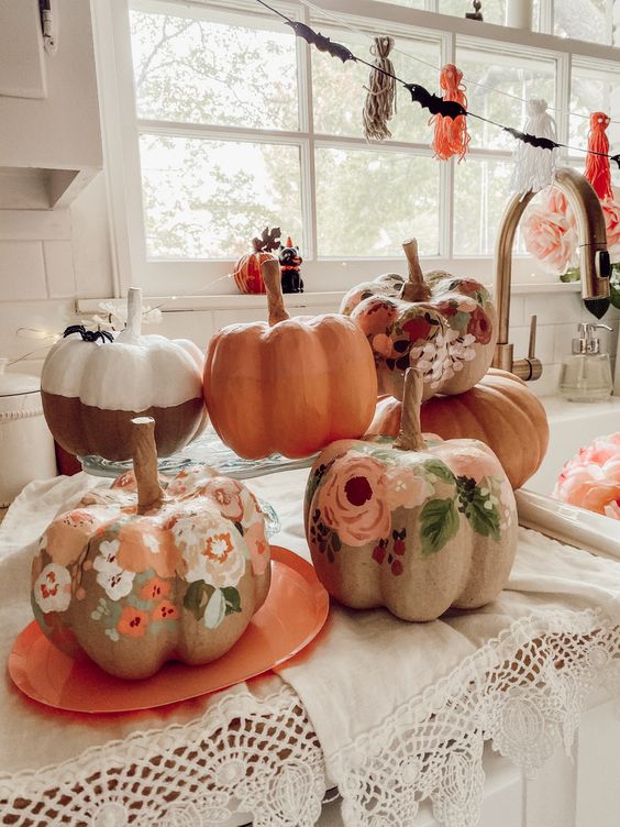 earthy-toned painted floral pumpkins are a pretty solution for a rustic or boho fall or Halloween space