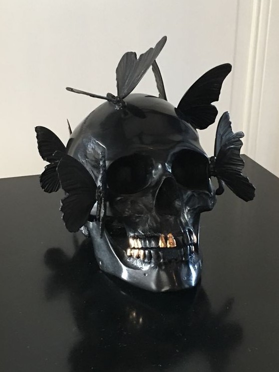 a black skull decorated with butterflies is a gorgeous and very creative Halloween decoration and looks very eye-catchy