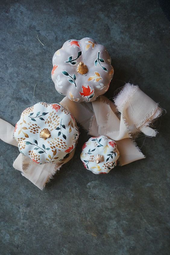 white pumpkins painted with bold blooms and leaves look very cute and cozy and will make your fall decor cooler