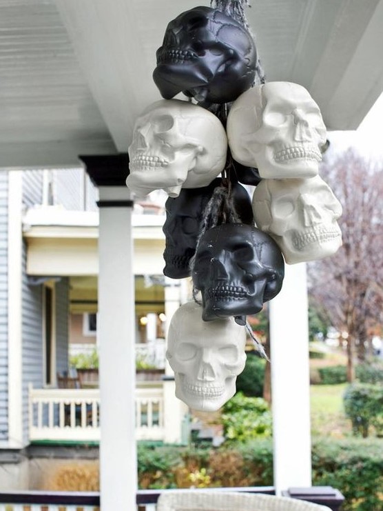 a bunch of black and white skulls is an easy idea to decorate indoors or outdoors for Halloween and looks cool