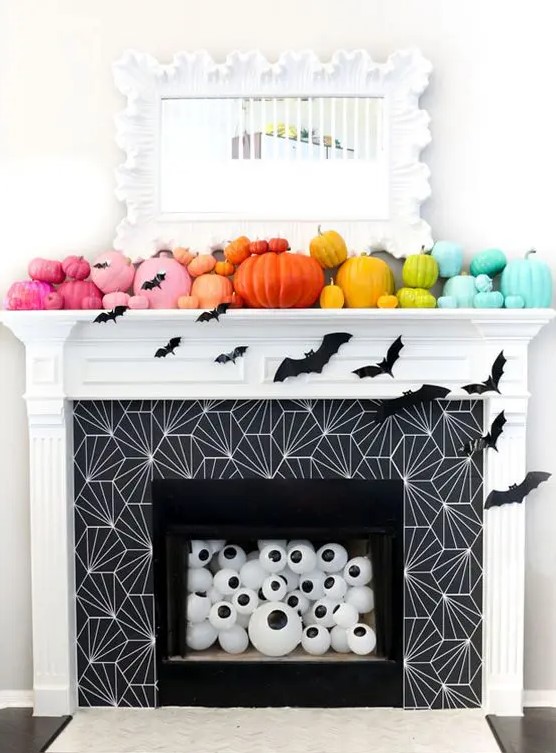 a rainbow pumpkin mantel with bats, eyeballs in the fireplace for fun and bold Halloween styling