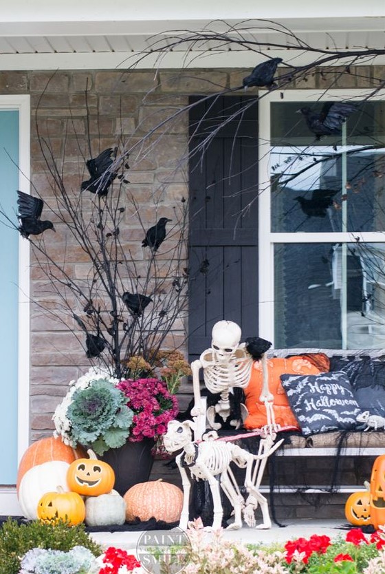 a cozy rustic Halloween scene with a skeleton petting its skeleton dog, blackbirds and jack-o-lanterns is lovely