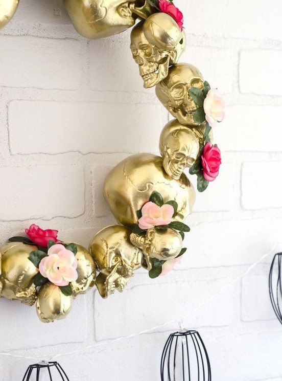 a gold skull wreath with flowers and greenery is an elegant and refined Halloween decoration