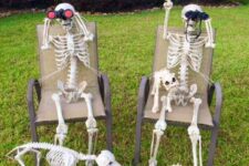 24 a fun skeleton Halloween scene with skeletons sunbathing, a skeleton cat and dog is a cool idea