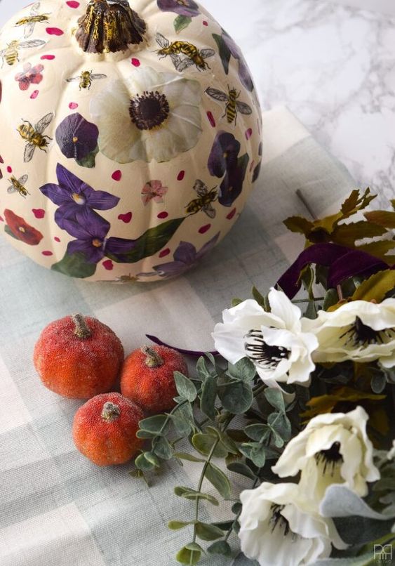 a white pumpkin with purple, red and white decoupage blooms and petals looks amazing and will be perfect for fall decor