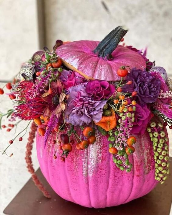 a gorgeous hot pink pumpkin with hot pink, fuchsia, red, violet blooms, orange berries and foliage for bold fall decor