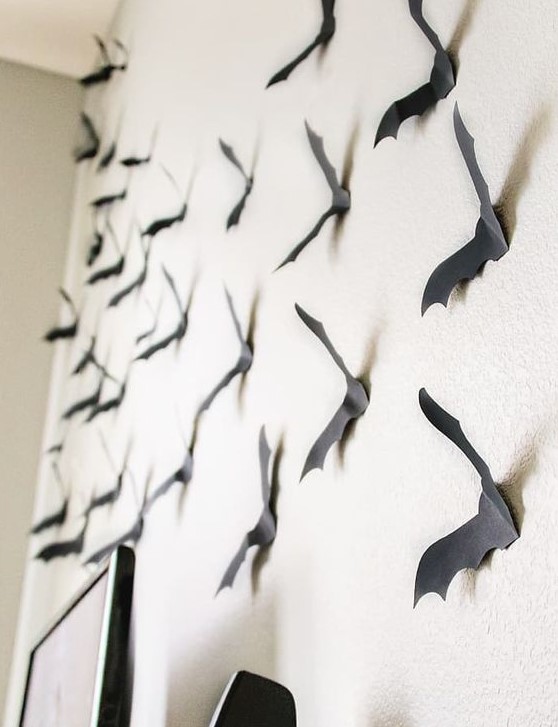 attach black paper bats to the wall to give a Halloween feel to the space at once and make it cool easily