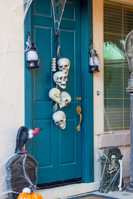 a skull hanging will be a nice idea for decorating your front door for Halloween, instead of a usual wreath