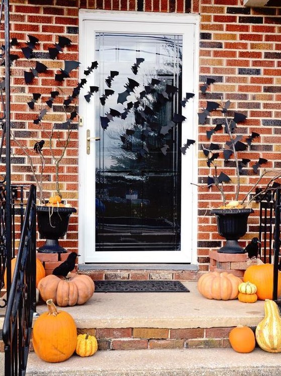 simple and stylish Halloween porch decor with heirloom pumpkins, blackbirds and bats on the walls and door