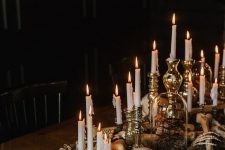 36 creepy and chic Halloween decor of skulls, bones, moss and candles in refined vintage candlesticks looks stylish and very elegant